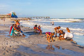 Black family enjoys the beautiful beach in St. Augustine, Florida