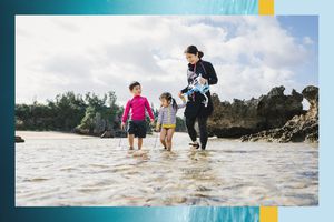 Mother with two children in the water on a tropical island