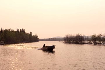 Peter Enzoe in his boat on the water near Frontier Fishing Lodge