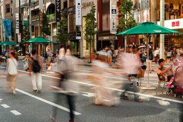 Long exposure motion blurred image of shoppers in the high-end shopping area of Ginza in central Tokyo, Japan