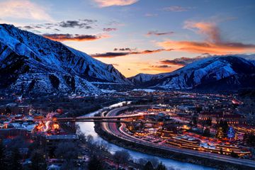 Colorado River flowing through the heart of Glenwood Springs Colorado at dusk during blue hour. Sunset skies.