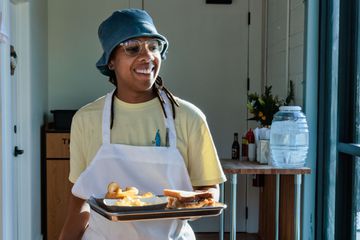 Chef Ashleigh Shanti with a tray of food at Good Hot Fish in Asheville, NC