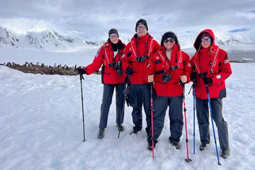 A family on a snowy glacier in Antarctica