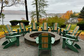 Adirondack chairs around a fire pit at Schroon Lake Hotel