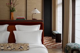 A guest room bed inside Hotel Hana