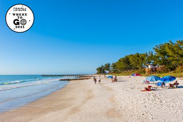 Tourists enjoying a beautiful sunny day on Manatee Beach on Anna Maria Island, a barrier island on the Florida west coast.