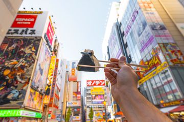 A person eating Onigiri in Tokyo, Japan