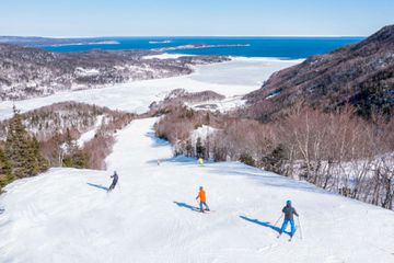 Skiers going down a mountain on Cape Smokey island in Nova Scotia