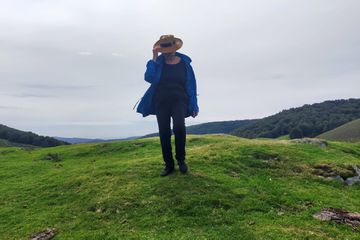 A mature woman on a green hillside of Spain 