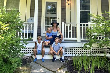 Mother with three children on the porch at Hidden Pond Resort 