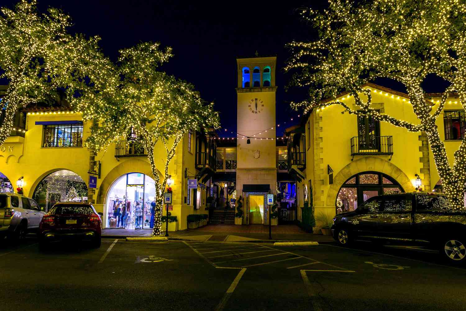 Highland Park Village shopping center and clock tower illuminated at night