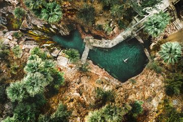Aerial view of a woman in the springs at Castle Hot Springs