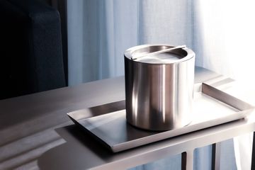 Silver stainless steel ice bucket and tray in hotel room