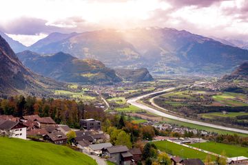 Scenic aerial view of hillside villages in Triesenberg and the river Rhine, natural border of Liechtenstein, an alpine country in central Europe, to Switzerland