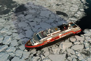 A cruise ship breaks ice