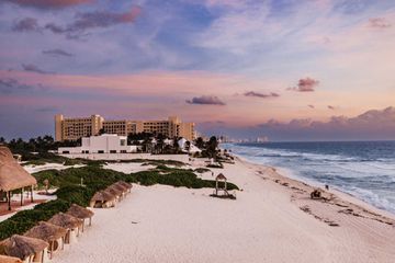 View at sunset from the balcony of the suite. The beach and coastline are in view 