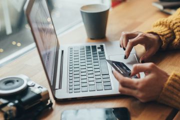 A woman on her laptop with a credit card