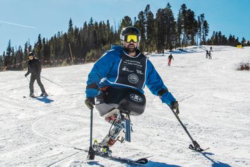 Paraplegic person skiing down a hill