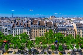 Paris, typical roofs in the Marais, aerial view with the Eiffel Tower and the Defense in background