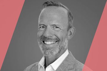 A black and white (grayscale) portrait of a person listed in the text as A List Travel Advisor