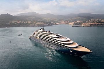 A yacht sails near a harbor