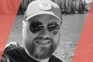 Black and white portrait of a person who is listed as an A List Travel Advisor 
