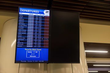 Flight information screens at International Airport after Hurricane Milton.