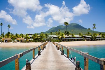 Stunning Pinney's beach with Coconut Palms, and the Volcano in the distance, at Nevis. Caribbean