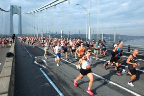 Men run across a bridge in New York City during the marathon