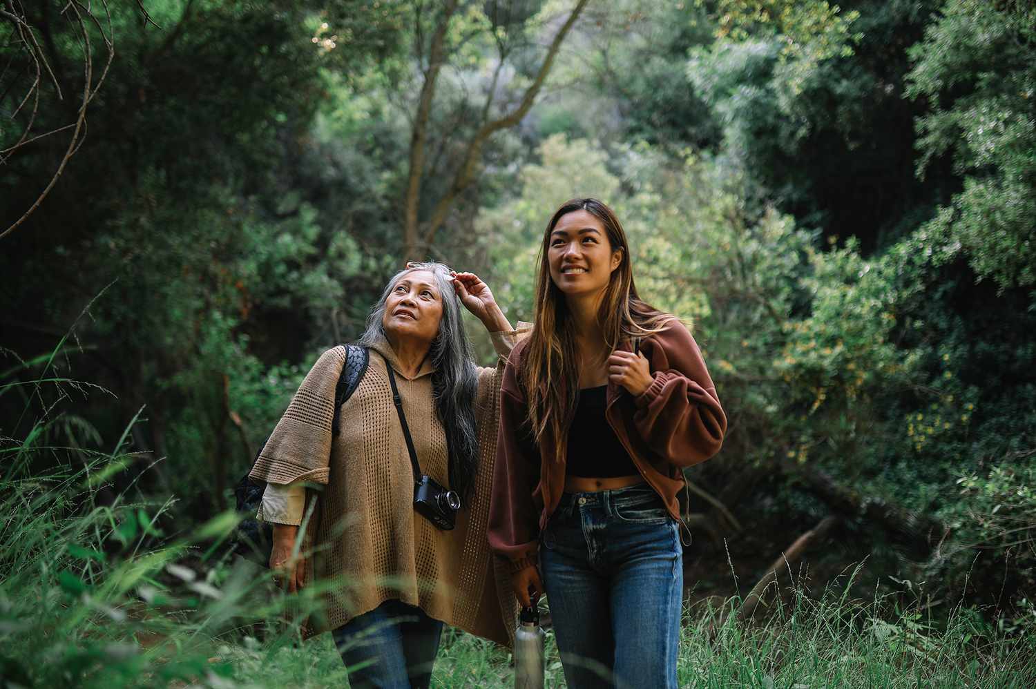 older mother and daughter hiking on vacation together 