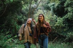 older mother and daughter hiking on vacation together 