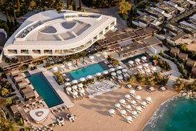 Overhead view of the main building, pool, and beach at the One&Only Aesthesis hotel
