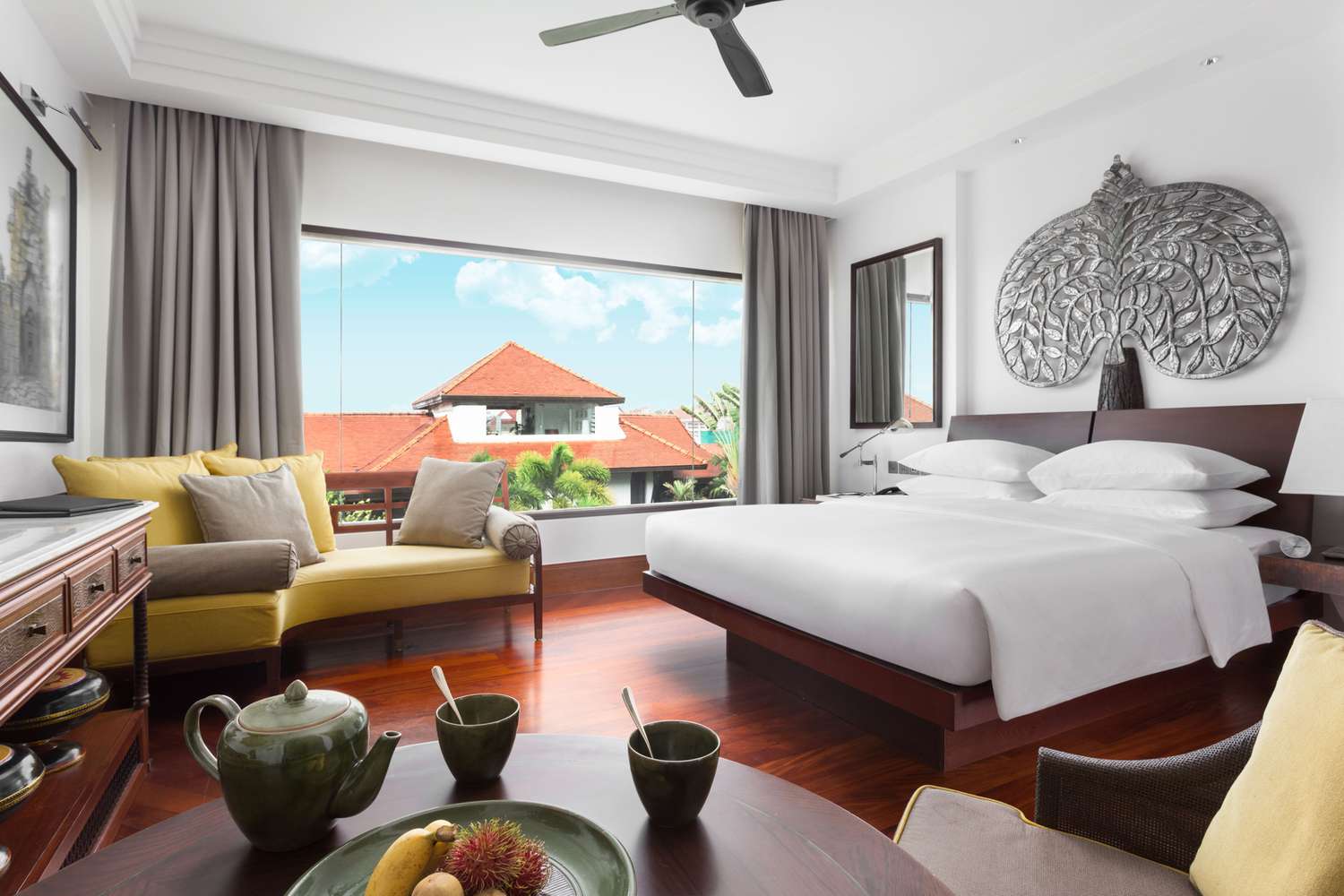 A guest room with a large window at the Park Hyatt Siem Reap