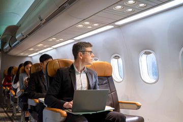 Passengers are sitting in the commercial plane.
