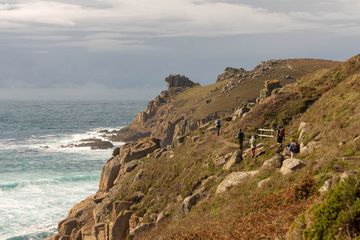 A group of people hiking along the coast in Cornwall