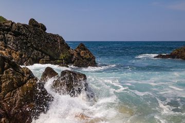 Waves crash on the rocks in Playa Mayto in Jalisco, Mexico.