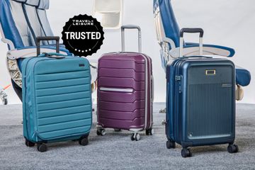 Three carry-on suitcases on a plane