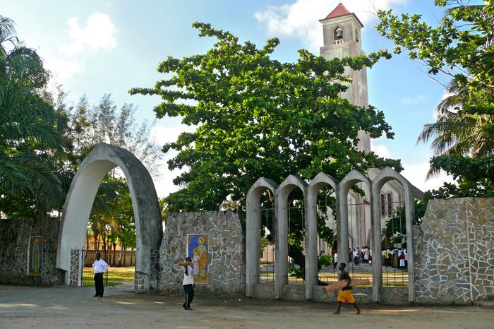 People walk in front of a church in Quelimane, Mozambique