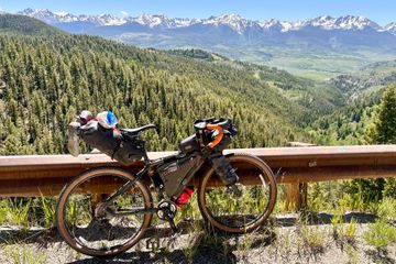 Revelate Designs Spinelock 16L Seat Bag on a bike with mountains in the background