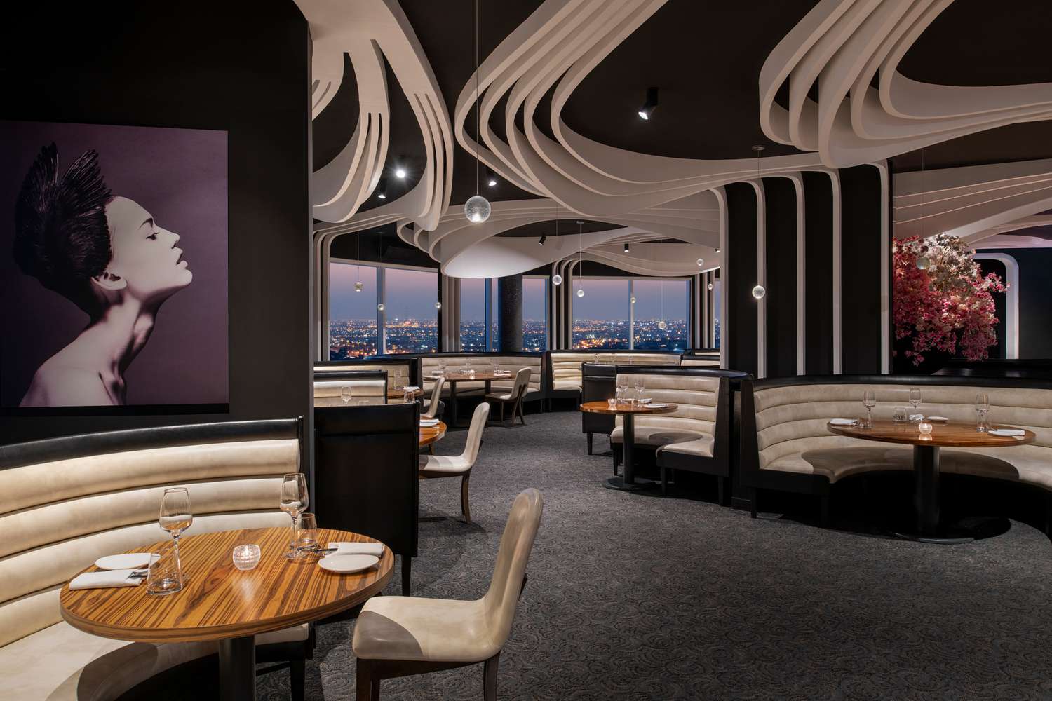 Dining room with city views at the Ritz-Carlton Doha, at night