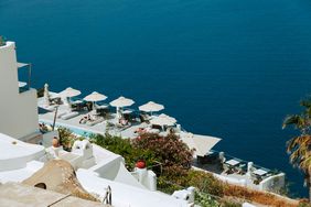People sunbathing at a resort on Santorini