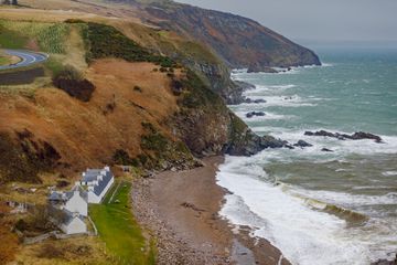 Overhead view of a rocky coastline and beach in Scotland