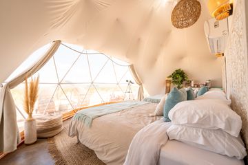 A bed in a tented dome