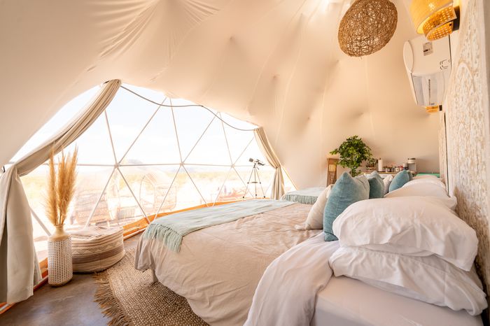 A bed in a tented dome