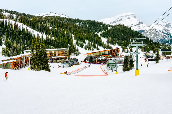 Skiers on a charlift by Sunshine Mountain Lodge