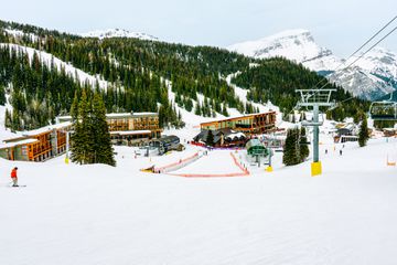 Skiers on a charlift by Sunshine Mountain Lodge