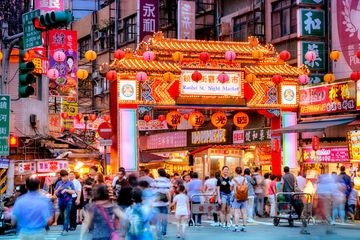 Night market in Taipei, with crowds and bright lights