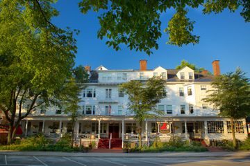 A tree-lined road and exterior of The Red Lion Inn in the Berkshires