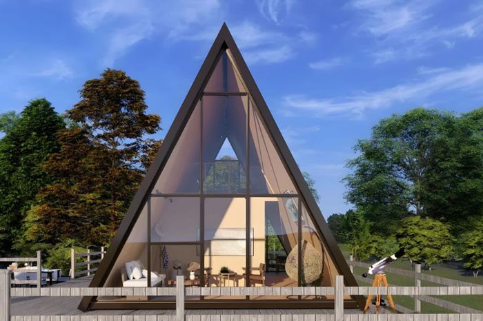 An a-frame tiny home in a cabin style set up outdoors