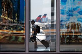 A traveler passes through O'Hare International Airport on June 30, 2022 in Chicago, Illinois.